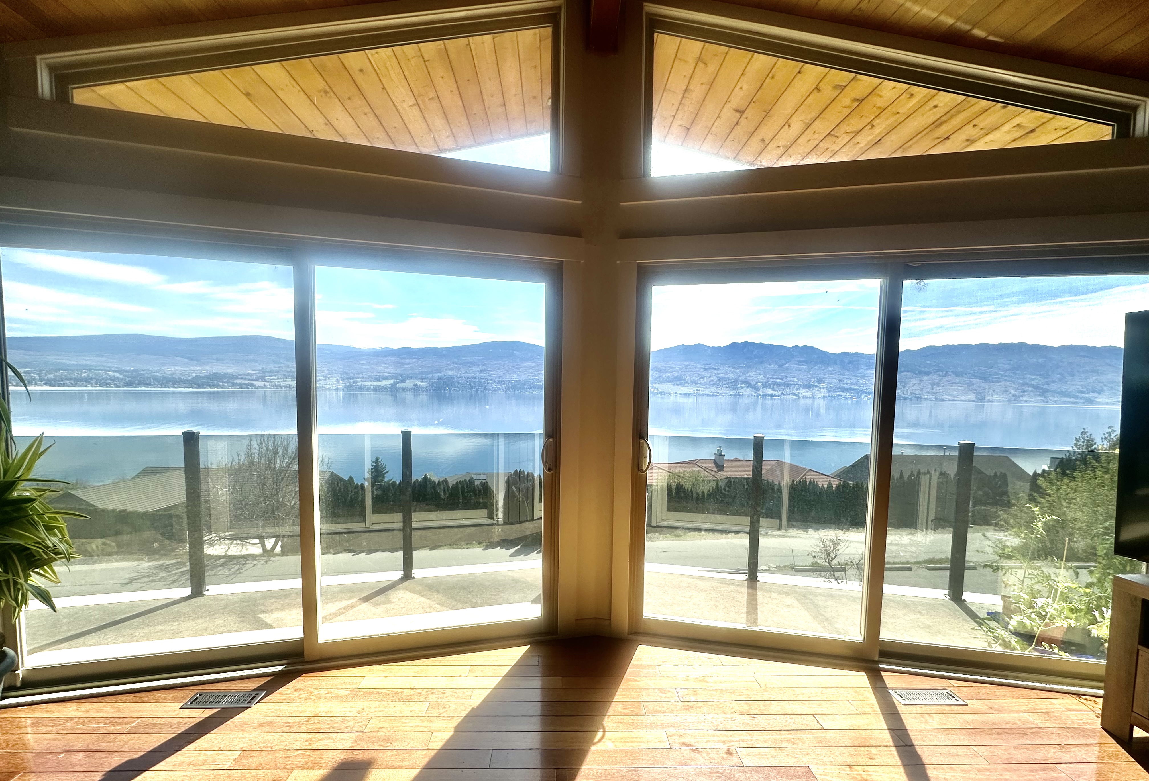Interior view through large windows toward Okanagan Lake