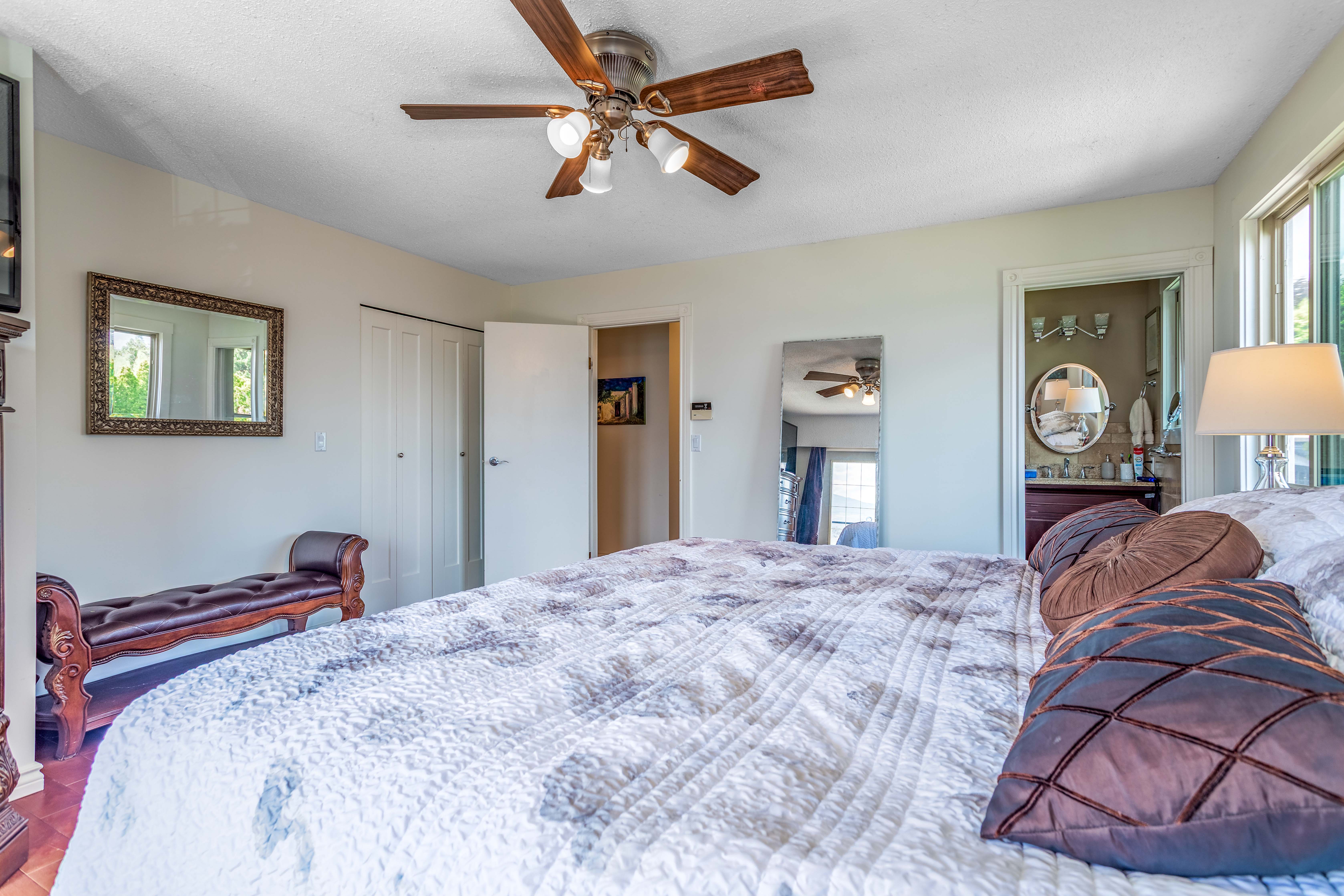 Master bedroom with ceiling fan and en suite