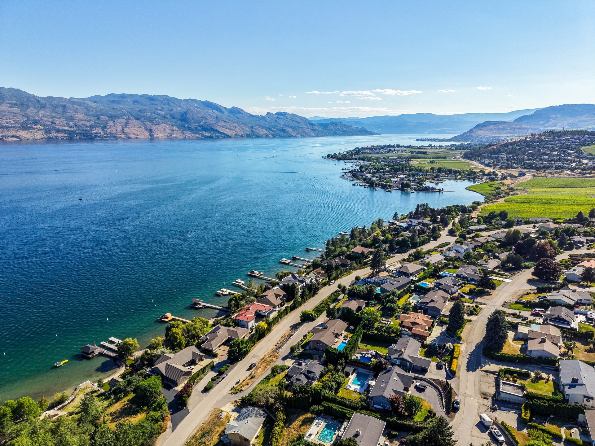 Aerial panorama of Okanagan Lake shoreline, vineyards and West Kelowna neighbourhood